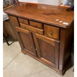 A stained pine six drawer effect single drawer, two door sideboard,