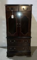 Mahogany three-door lift-top music cabinet with inlay together with a Sony music system,