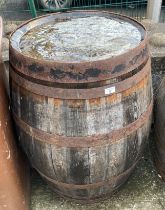 An aged oak whisky/sherry barrel with metal banding,