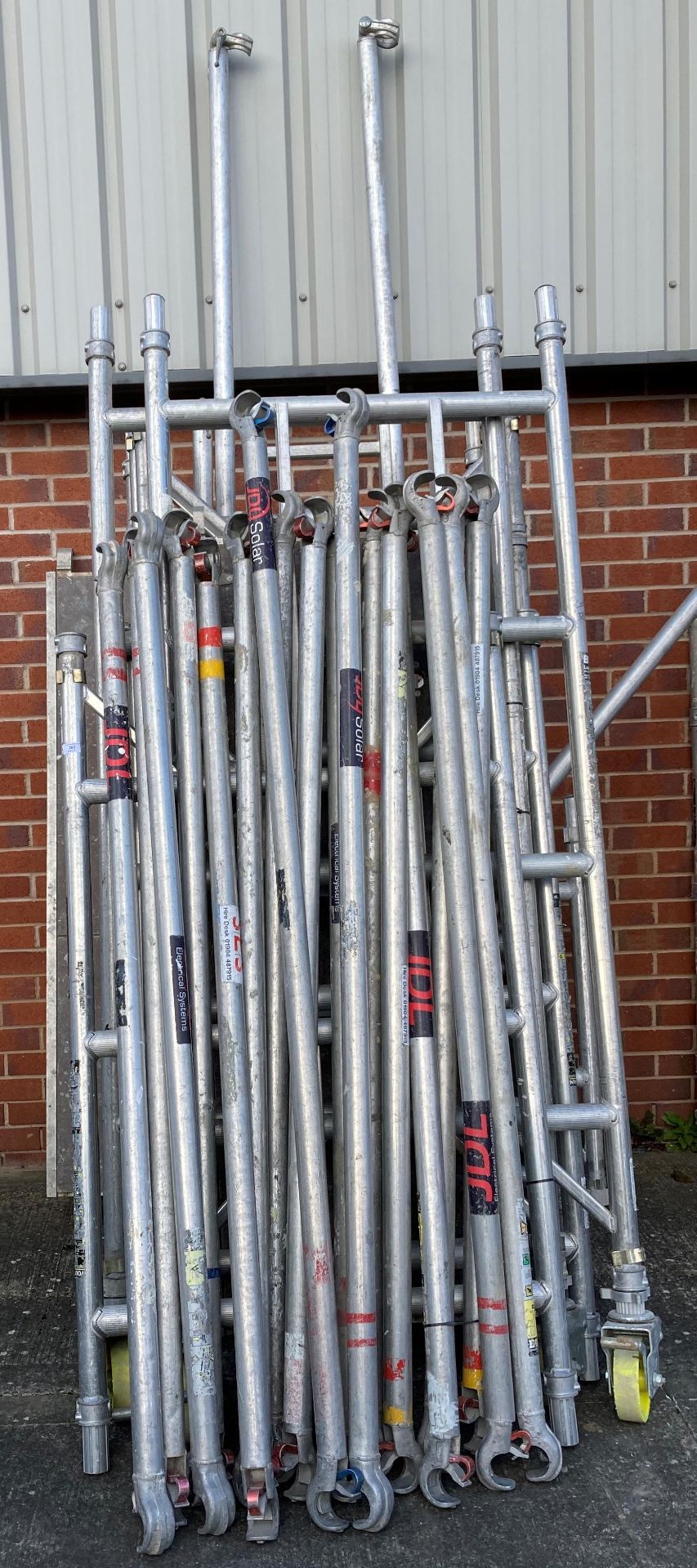 Aluminium scaffold tower comprising of eleven 4 rung 'H' frames, 2 x outriggers, 2 x walk boards,