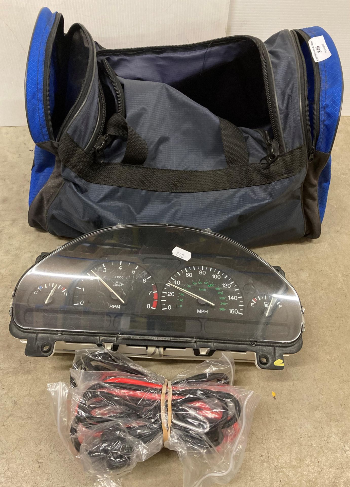 Jaguar 1999 instrument cluster and a blue fabric bag (saleroom location: S05-2)