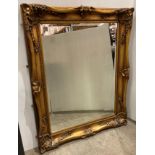 Large ornate gilt framed wall mirror with bevelled edge,