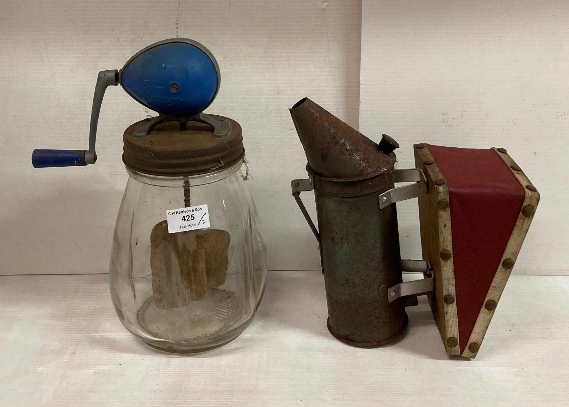 Two items including Blow manual glass butter churning jar and a bee smoker (saleroom location: K10)