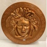 Circular gilded plastic Medusa wall hanging,