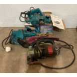 Three assorted power tools including a Makita 82mm power planer (240v), Makita 76mm belt sander,