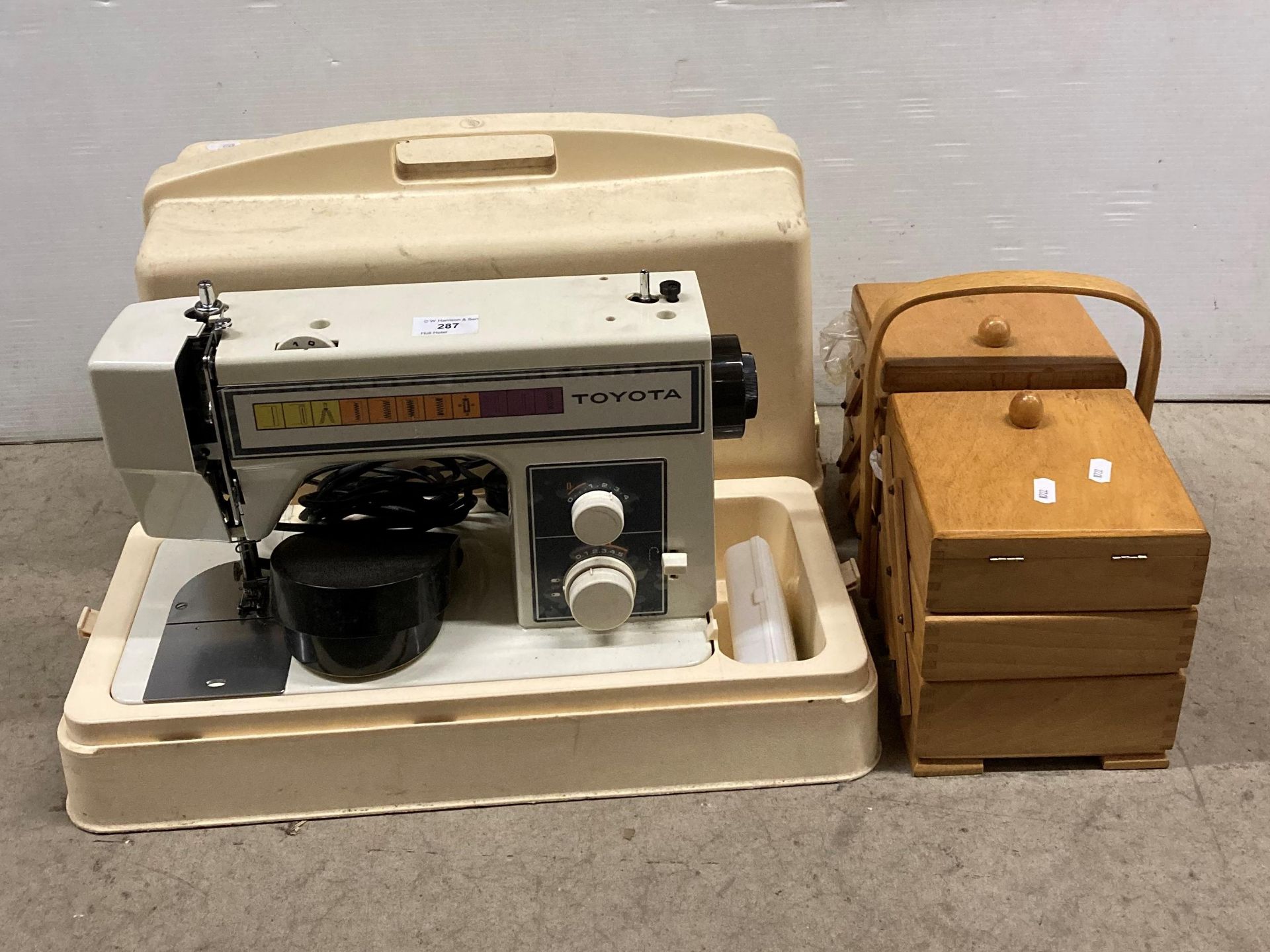 Toyota electric foot-operated sewing machine in carrying case - model: 222 - and a wooden