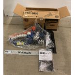 A boxed Hyundai petrol chain-saw,