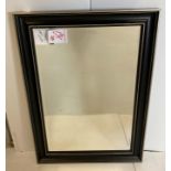 A rectangular mirror in black and gilt frame,