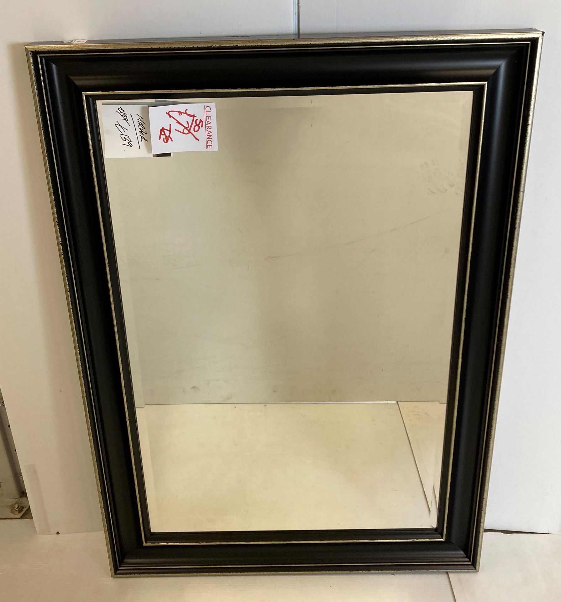 A rectangular mirror in black and gilt frame,