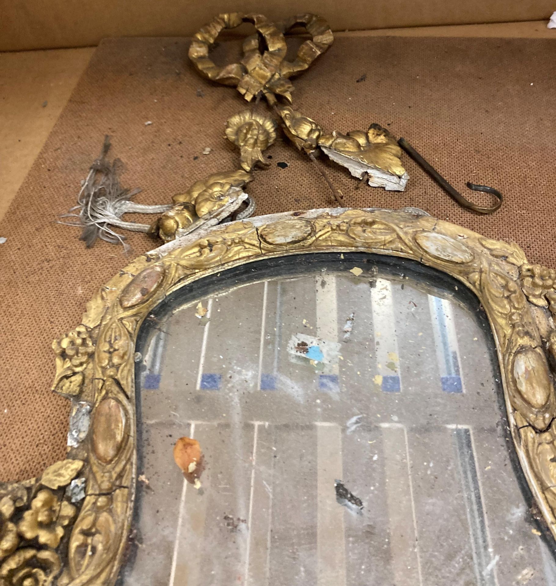 A 19th Century ornate gilt framed wall mirror - with damages - approximately 57cm x 34cm (sold as - Image 2 of 3