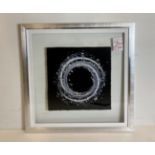 Liquid crystal circular artwork 'Silver Stardust' in chrome surrounded by glass frame,