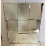 Large rectangular mirror wall display with nine mirrors, set at varying angles,