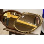 Two oval wall mirrors,