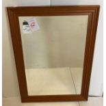 A rectangular mirror with cherry wood frame,