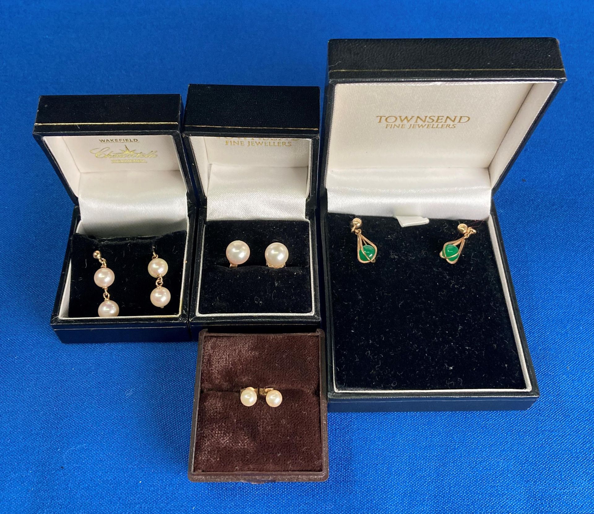 Four pairs of assorted 9ct gold earrings - three pairs decorated with pearls and one pair with a