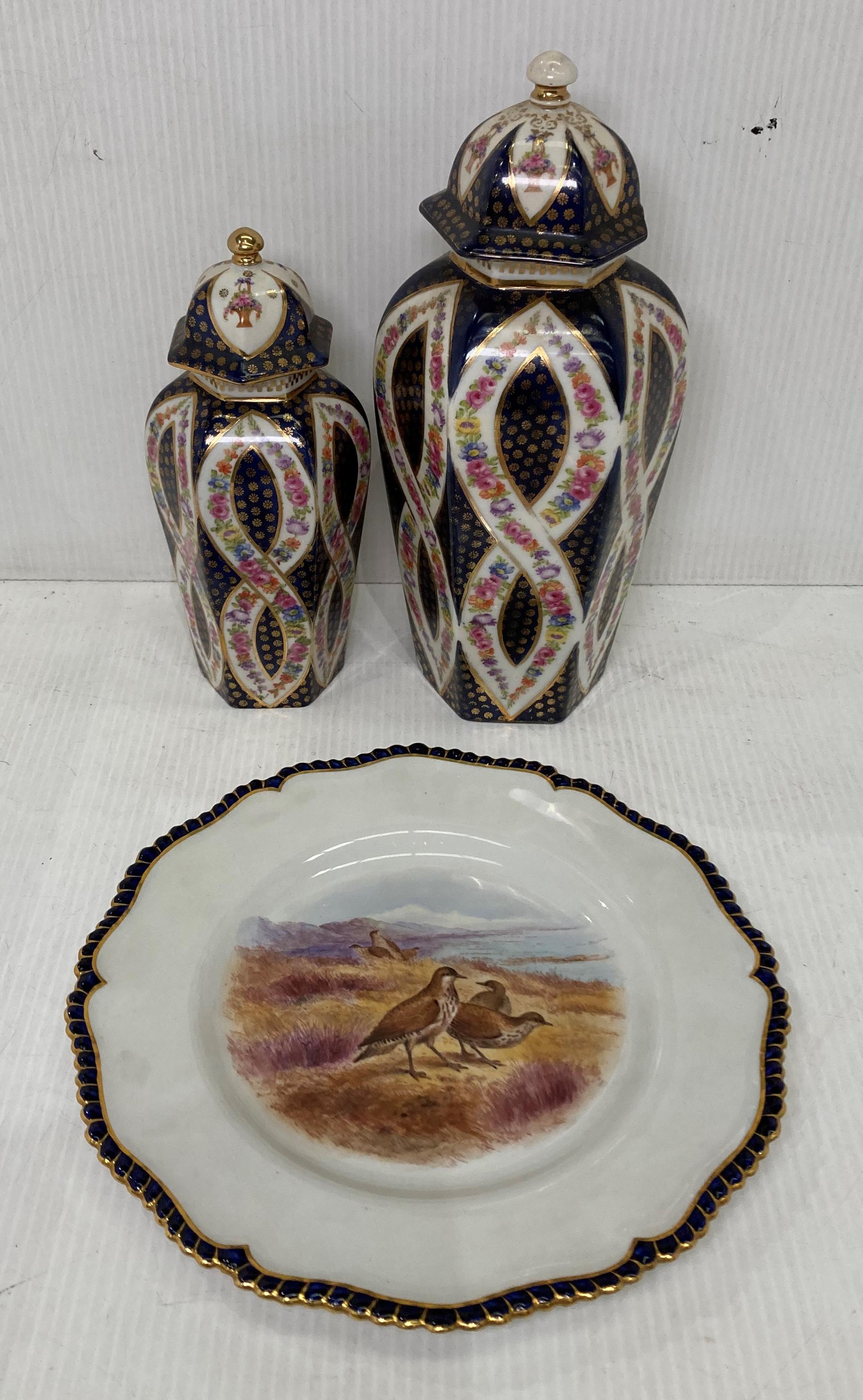 A Royal Worcester Vitreous 23cm diameter plate and two Victoria Austria lidded vases 20cm and 26cm
