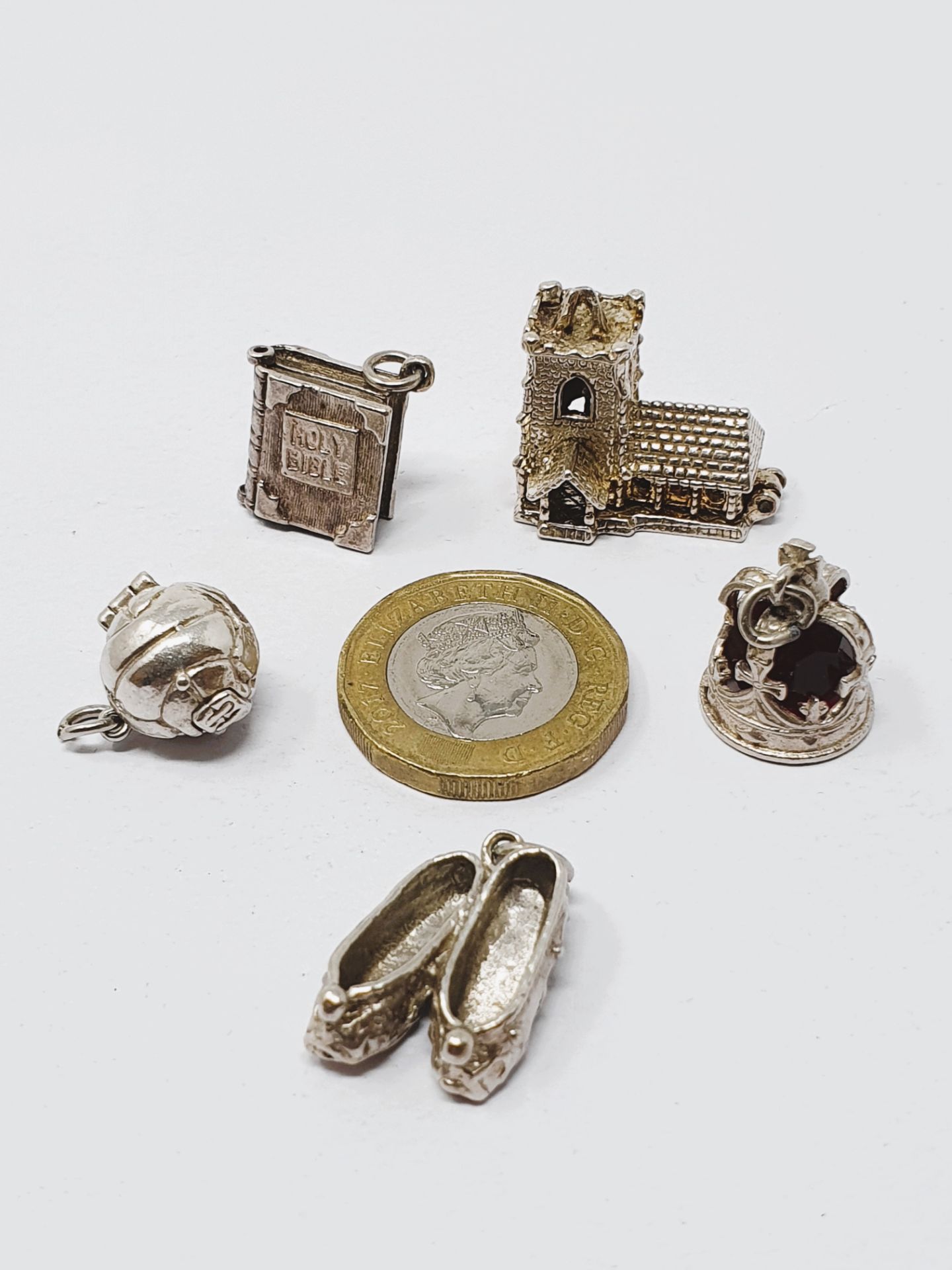 Sterling silver selection of fifteen vintage charms, including crown, football, bow and bells,