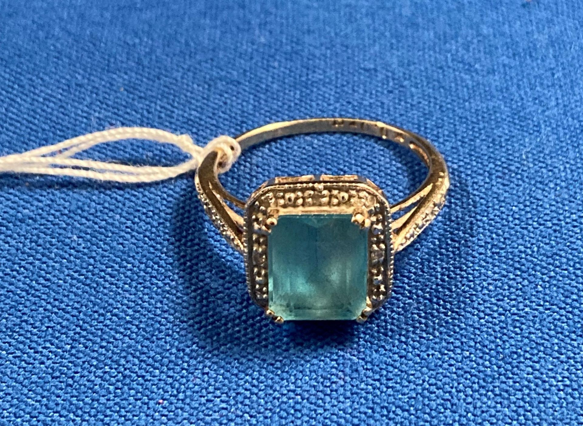 9ct gold ring with diamonds and a central light-blue stone (possibly aquamarine) size 'S'. Weight 3.