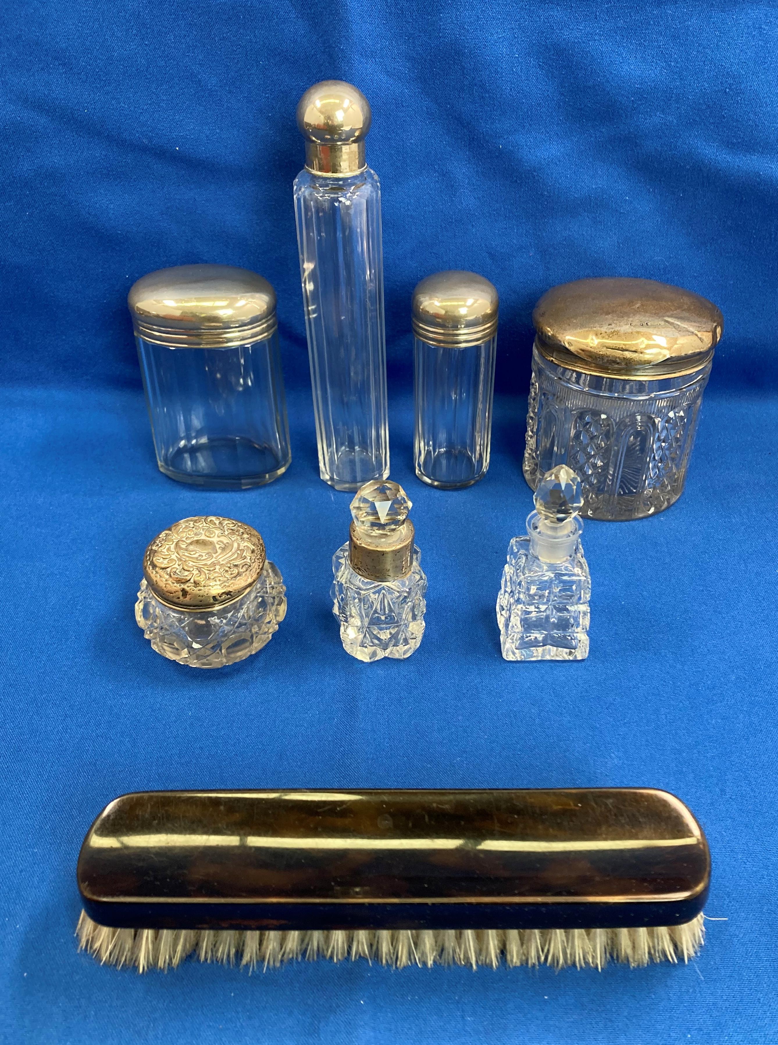 Contents to box - three silver top (hallmarked) dressing table set items and a set of three glass