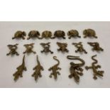 Seventeen brass animals including twelve frogs/toads, crocodiles and lizards,