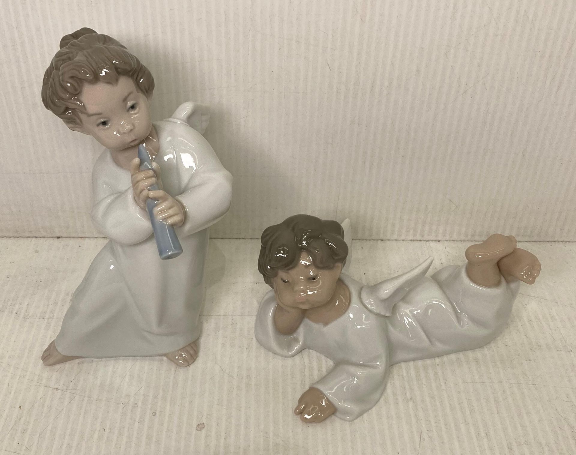 Two Lladro Angel figurines including Angel with Flute (with box - 16cm high) and a Laying Angel - Image 2 of 3