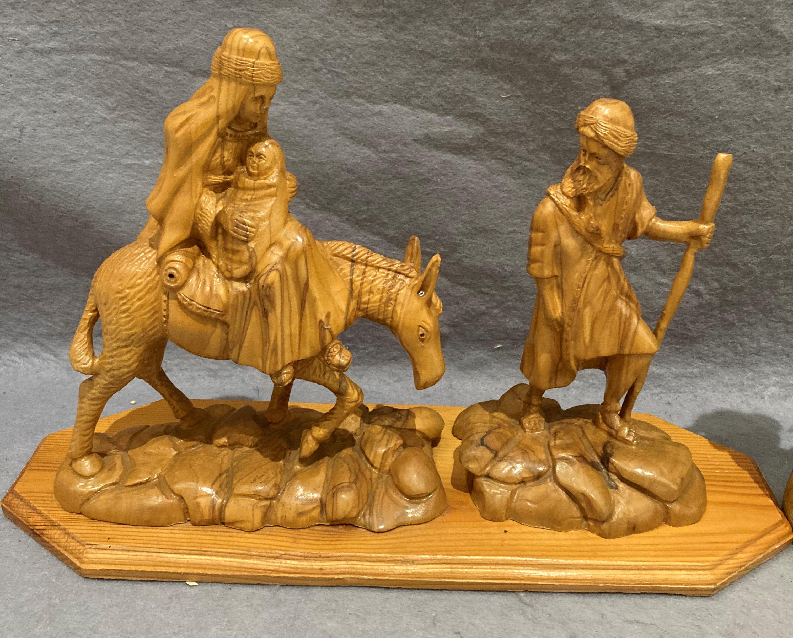 A hand-carved olive wood 'Flight to Egypt' religious carving on wooden plinth (35cm x 22cm high) - Image 2 of 4