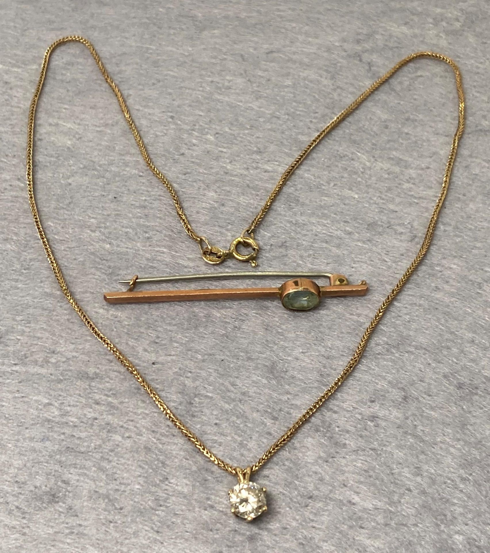 Two 9ct gold (375) items including a rope chain (16" long) with a 9ct gold single stone pendants