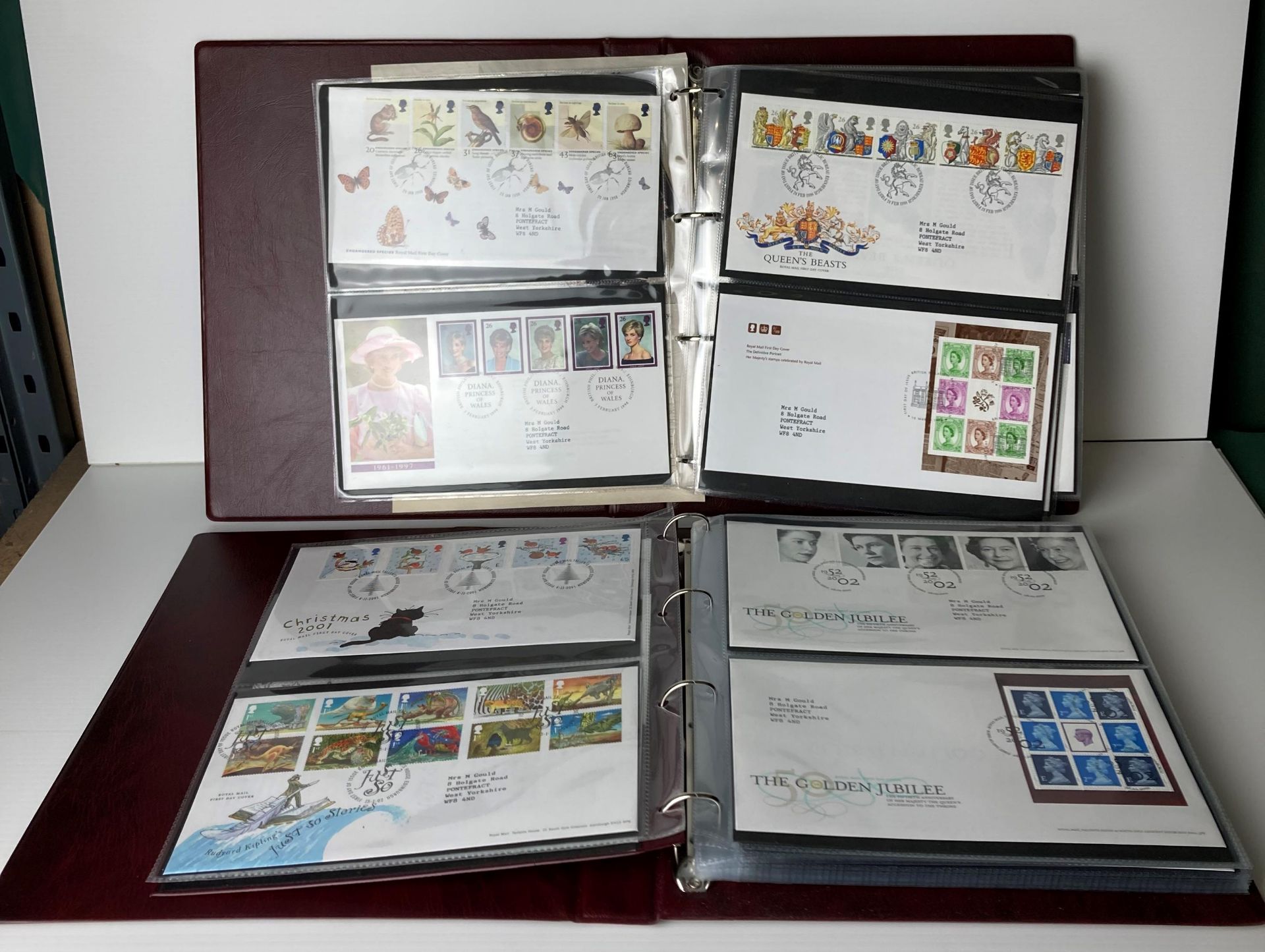 Two Royal Mint First Day Cover folders with approximately 105 First Day Covers stamps including