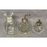 Two vintage perfume crystal/glass bottles with Sterling Silver tops/pumps (9cm and 14cm high) and a