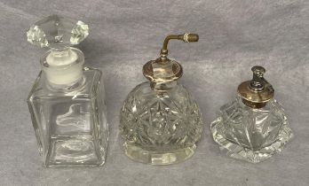 Two vintage perfume crystal/glass bottles with Sterling Silver tops/pumps (9cm and 14cm high) and a