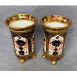 Two Royal Crown Derby spill vases in Imari pattern on paw feet,