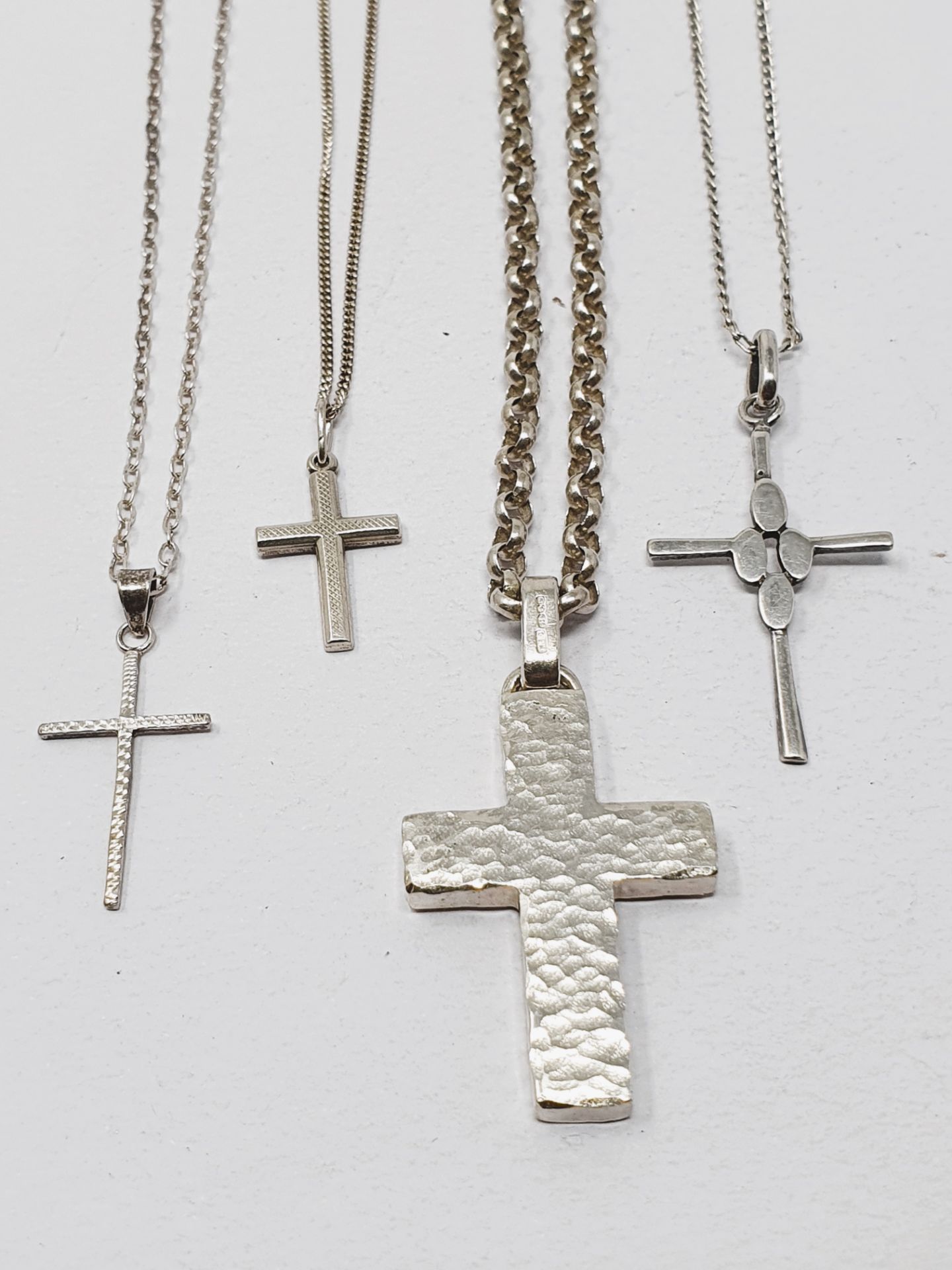 Sterling silver, three pendants with chains and four crosses with chains, gross weight 42.