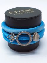 STORY' by Kranz & Ziegler blue silk wrap bracelet with three sterling silver charms, unworn / boxed,
