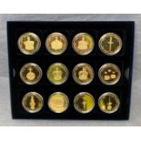 A set of twelve 24ct gold plated coin collection depicting the 2004 Turks & Calcos Island Crown