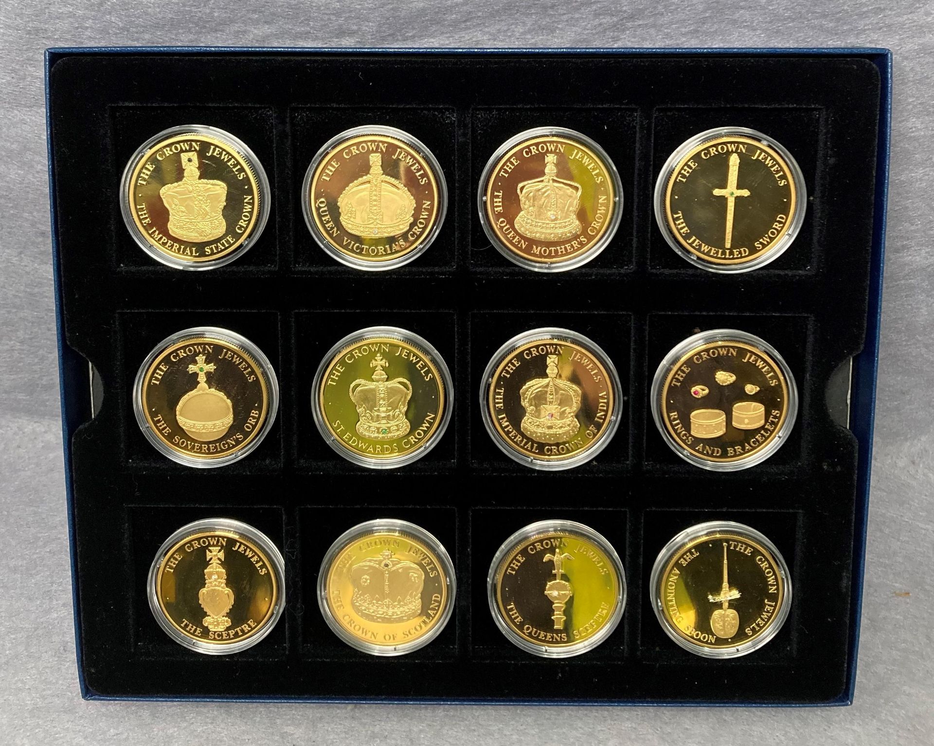 A set of twelve 24ct gold plated coin collection depicting the 2004 Turks & Calcos Island Crown