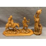 A hand-carved olive wood 'Flight to Egypt' religious carving on wooden plinth (35cm x 22cm high)