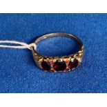 9ct gold (375) ring with red stones (possibly garnet) size S. Weight 2.