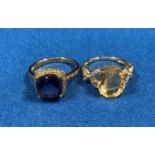 Two 9ct gold (375) rings - an oval lemon-coloured oval cut stone with butterfly design to either