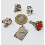 Sterling silver selection of thirteen vintage charms, including driving licence, comb and brush set,