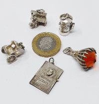 Sterling silver selection of thirteen vintage charms, including driving licence, comb and brush set,