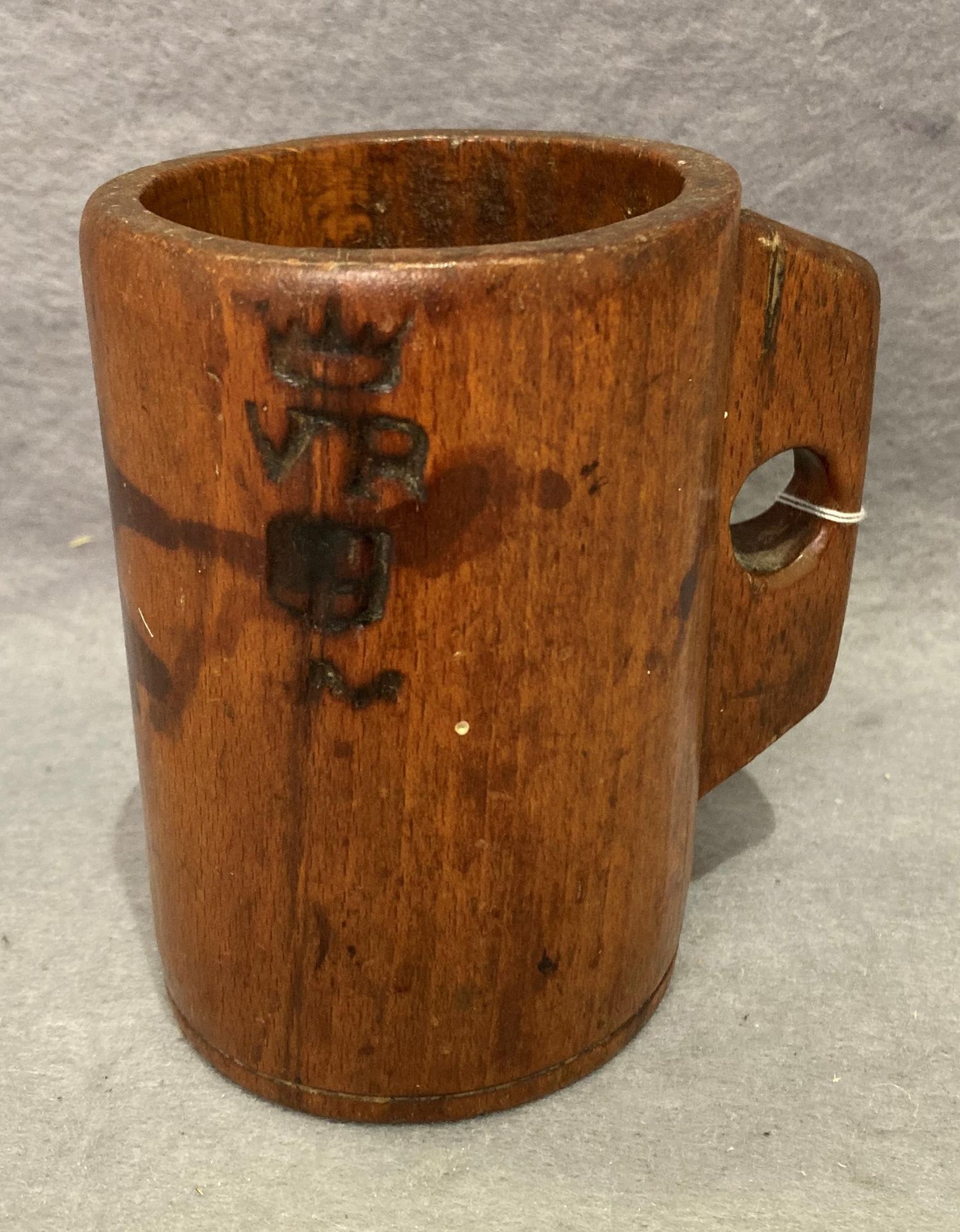 A Victorian wooden dry or wet measuring cup/mug with Crown & VR and one other stamp to outside,