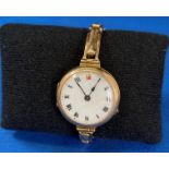 15ct gold (685) ladies watch with white enamel face and Roman numerals,