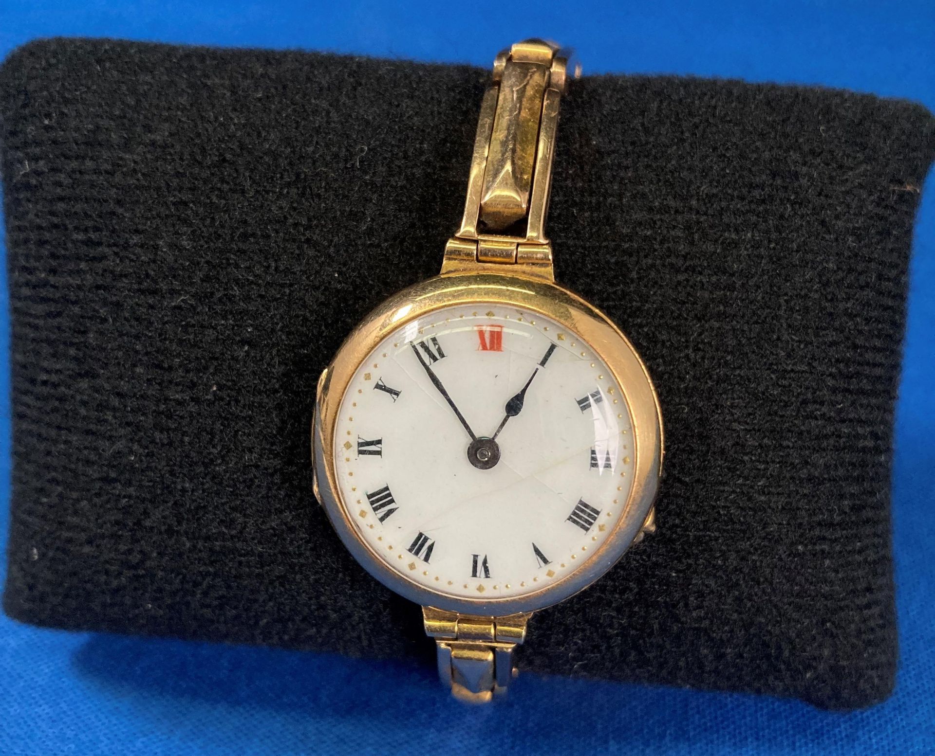 15ct gold (685) ladies watch with white enamel face and Roman numerals,