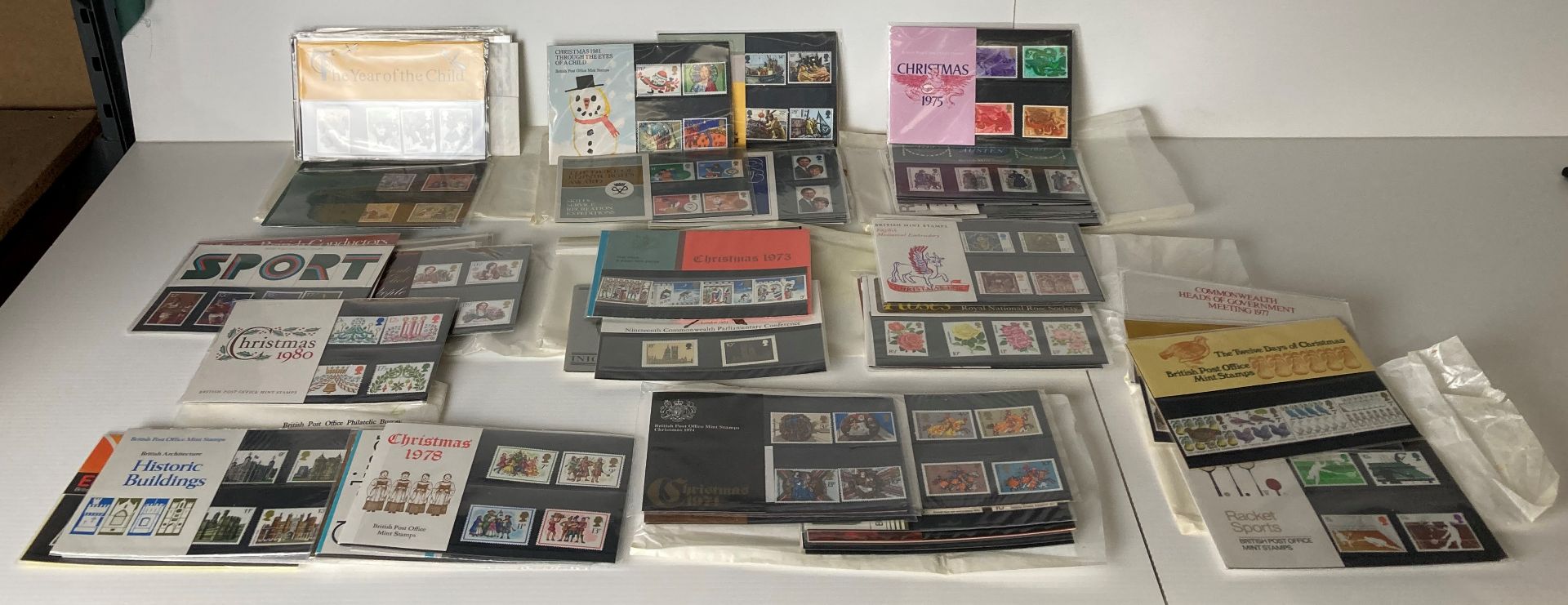 Sixty assorted packs of British Mint Stamps (1973-1981) including Christmas, Sports,