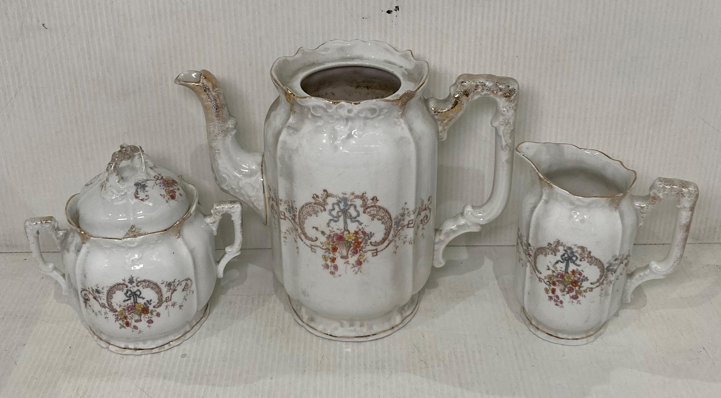 A late 19th Century Hermann Ohme three-piece tea service including sugar bowl (with lid), milk jug,