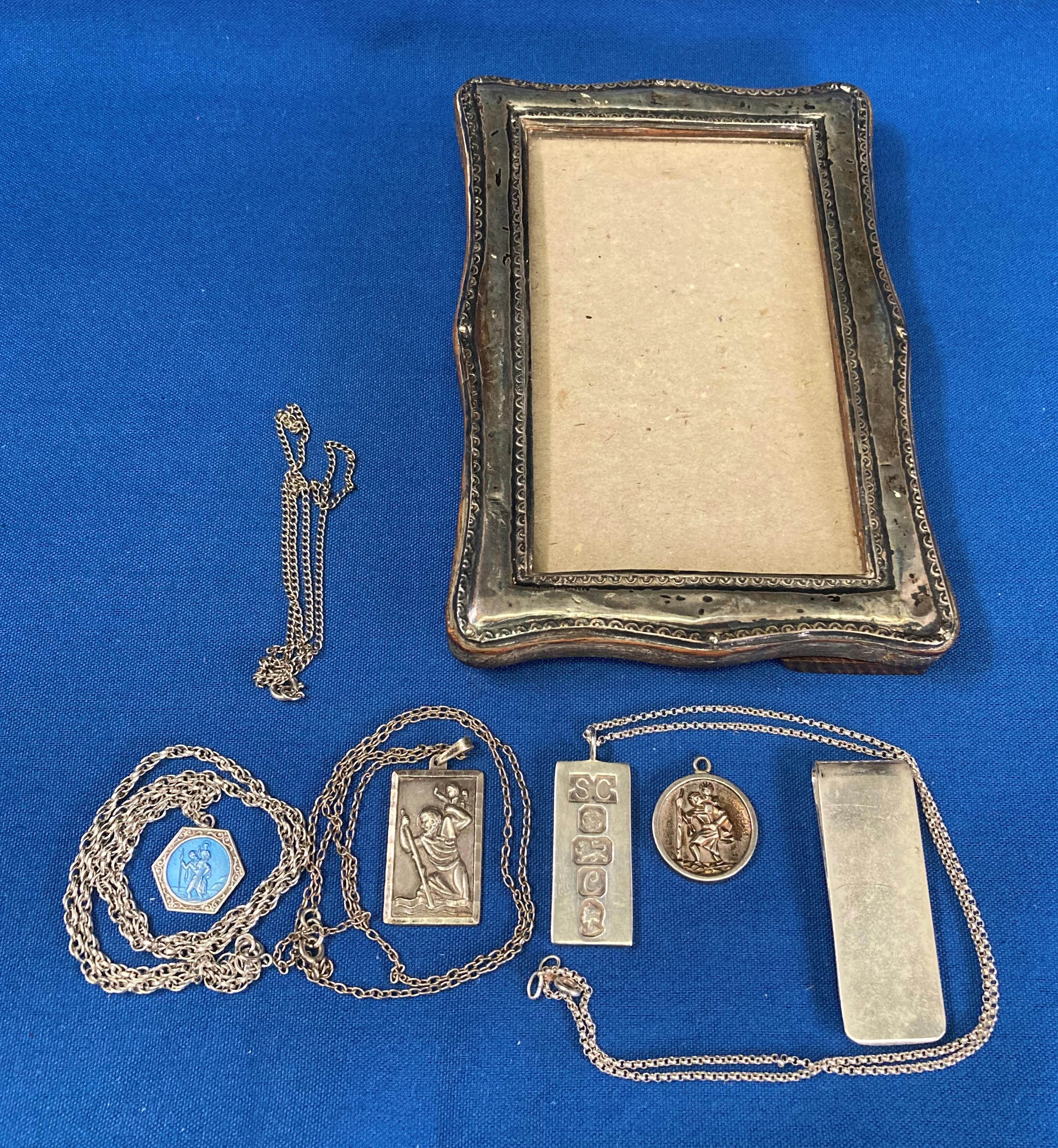 Four assorted silver (hallmark) chains and pendants including silver ingot,