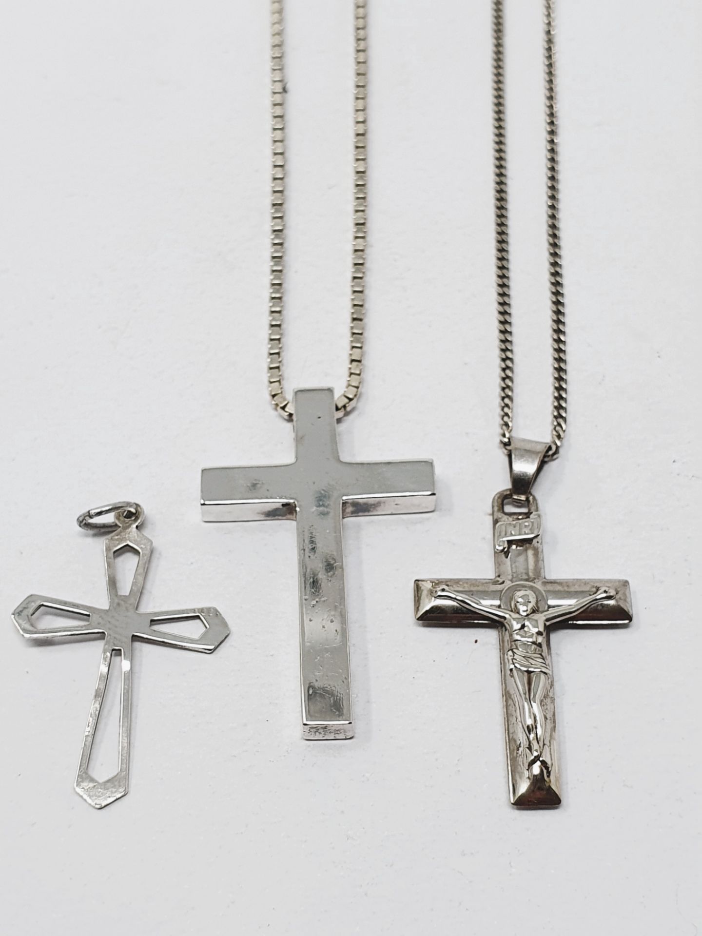 A sterling silver cross with chain, a sterling silver crucifix with chain,