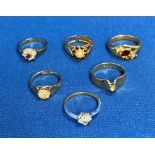 Six assorted rings including a two-tone yellow and white gold tone ring with clear stone (not