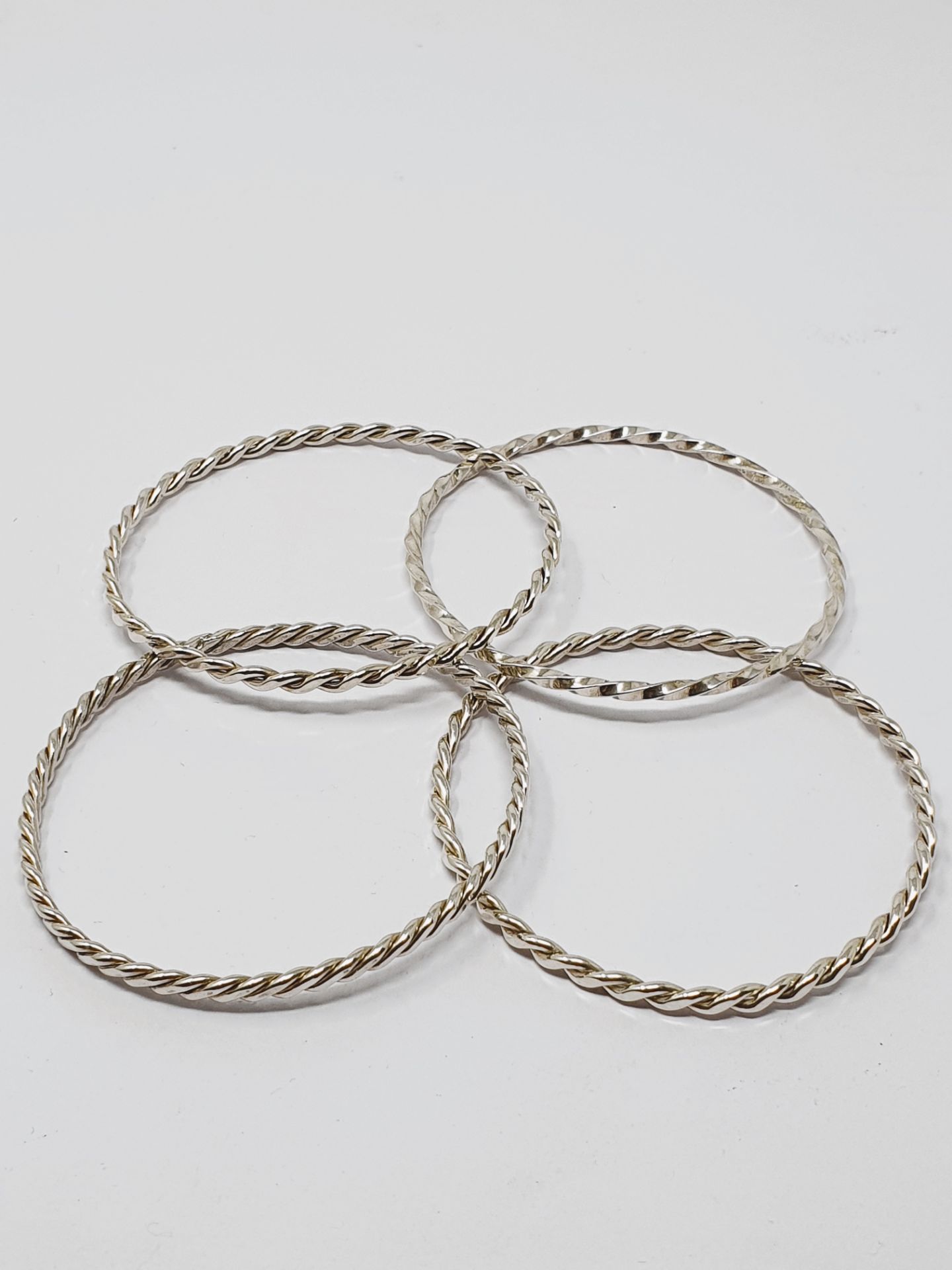 Four twisted, solid wire bracelets stamped 'STERLING', gross weight 48.