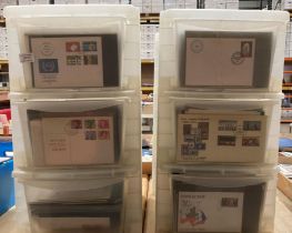 Two x three drawer plastic racks and contents - large quantity of First Day Covers,